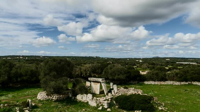 Talati de Dalt Ruins in Menorca Spain, overview from hillside as visitors explore the archaeological grounds