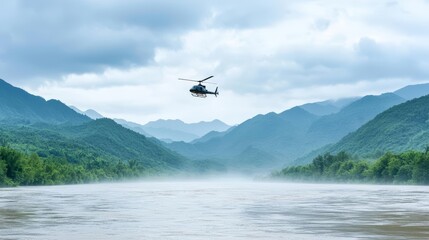 Helicopter flying over a serene river with mist and mountains in the background.