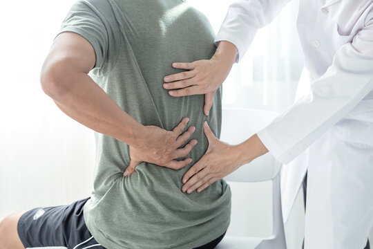 Male patients consulted physiotherapists with Low back pain for examination and treatment. Rehabilitation physiotherapy concept.