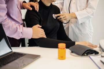 The female doctor measured blood pressure, the patient examined the heartbeat and sat down to talk...