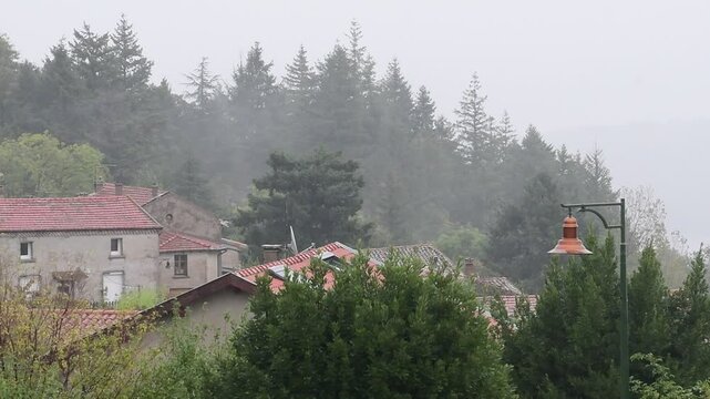Rainy weather in a mountain village in France in the Auvergne Rhone Alpes region. Rain in autumn.