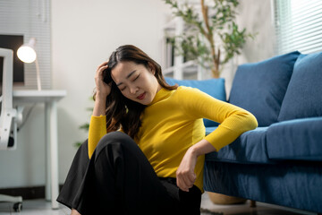 Fototapeta premium Young businesswoman is suffering from a headache while working from home