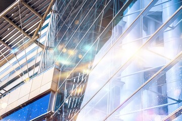 Naklejka premium Modern glass building with sun glare and reflections.