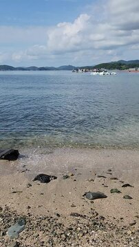 Sea waves hitting the rocks and sand in Manji Island (Manji-do) in Tongyeong, South Korea