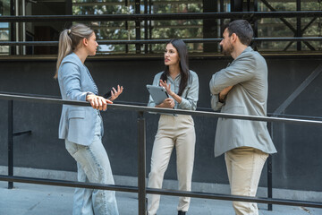 Group of young businesspeople stock market and exchange experts, leaders in modern science, finance and economy standing outside of office building. Staff members meeting businessman and businesswoman