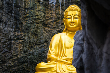 Samut Sakhon, Thailand - September, 25, 2024 : Golden Buddha Statue in Serene Cave in Lak Si Temple...