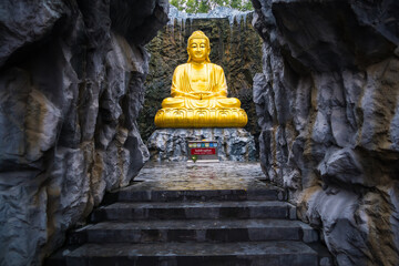 Samut Sakhon, Thailand - September, 25, 2024 : Golden Buddha Statue in Serene Cave in Lak Si Temple...