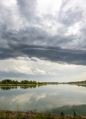 A cloudy sky with a lake in the background