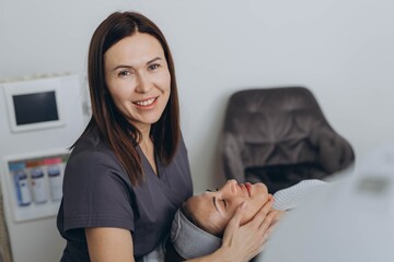 A beautiful woman enjoys a facial massage at a spa salon,indulging in skin and body care treatments.