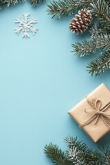 A beautifully wrapped gift surrounded by evergreen branches and winter decor on a blue background
