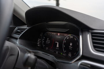 Fototapeta premium Close-up of a car dashboard showing a digital display with navigation, speedometer, and fuel information. High quality photo