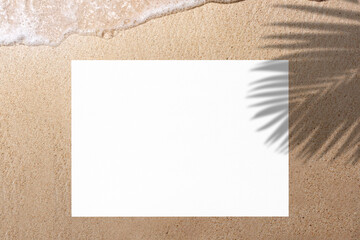Empty white paper for copy space and leaf shadow on sand