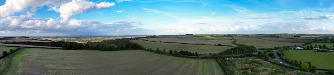 Fototapeta premium Aerial Panoramic View of British Agricultural Farms at Streatley Village and Countryside Landscape of Bedfordshire, England Great Britain of UK. Footage Captured with Drone Camera on October 7th 2024