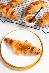 freshly baked delicious croissants with apricot jam