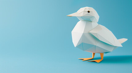 origami bird made from white paper, featuring a geometric design. The bird stands on a light blue background, with orange feet and a beak
