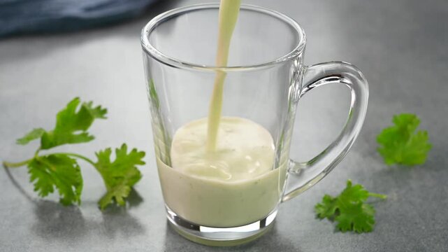 Serving masala buttermilk chaas in a glass cup.
