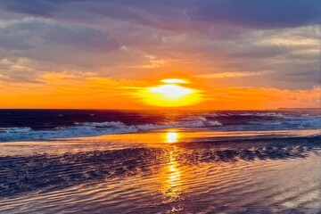 Golden Sunset Over Ocean with Reflective Waves