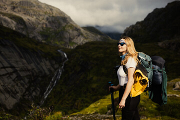 A Female Hiker Pauses to Take in the Breathtaking and Majestic Mountain Landscape 