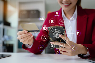 Female asian use credit cards to conduct financial transactions through phones, tablet at home...