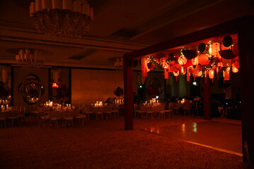 A Japanese themed stage in a ballroom with candle lit tables