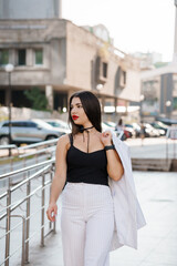 Fashionable Young Woman Walking in City with Stylish Outfit and Confident Attitude