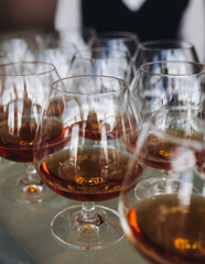 Alcohol setting on catering banquet table, bartender pouring liquor beverages, row line of different colored alcohol drinks on a party, glass of wine, sparkling wine on decorated banquet table event