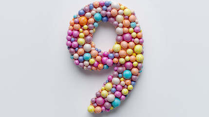 Obraz premium Colorful number nine crafted from various pastel and bright spheres arranged creatively on a light background