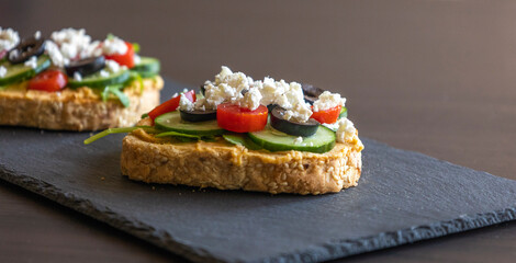 Mediterranean Hummus Toast with Cucumber, Tomato, Olive, and Feta - Close-Up