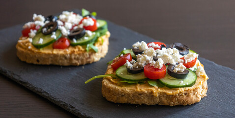 Mediterranean Hummus Toast with Cucumber, Tomato, Olive, and Feta - Close-Up
