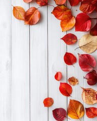 Fototapeta premium Autumn still life composition with harvest leaves on white wooden surface for seasonal promotions and holiday greeting card mockup
