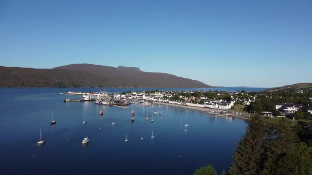 Take off drone shot of the docks at Ullapool, Scotland
