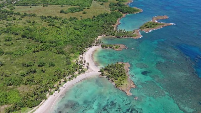 Coquitos Beach, Dominican Republic, showcasing crystal clear waters and a white sand beach in a tropical paradise. Orbit bird's eye view