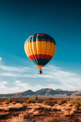 Obraz premium colorful hot air balloon soaring over desert landscape