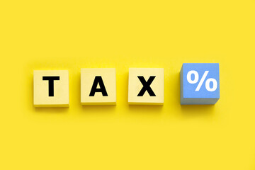 Tax payment concept; cube block with tax word and percentage symbol