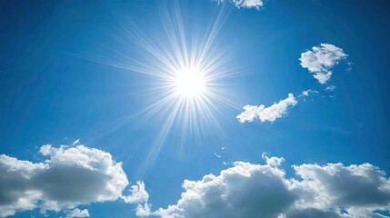 White clouds glowing softly in a radiant blue sky, with the sun shining through to create a peaceful, serene view.
