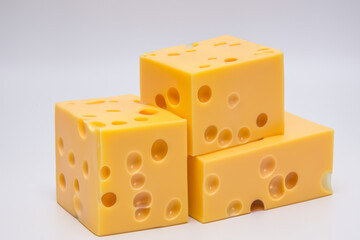 White with cubes cheese. food healthy fresh concept. a pyramid of cubes of cheese stacked on a gray . a pyramid with cubes of cheese stacked on top of each other lifestyle on a gray.