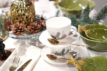 bright festive table setting for the New Year and Christmas with the help of glassware, ceramic products and linen tablecloth