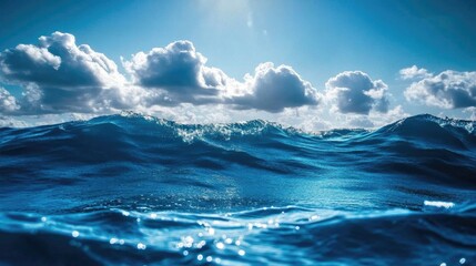 Fototapeta premium Deep blue ocean waves under a clear sky, sunlight reflecting on the water surface