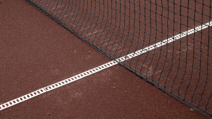 Tennis Court Lines and Net on a Red Clay Surface