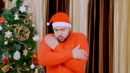 Indian Man Feeling Cold with Christmas Tree in background