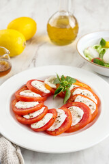 Salad Caprese with Sliced RedTtomato, Mozzarella, and Basil