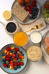 Assortment of various breakfast foods and drinks on the white table. Flat lay.