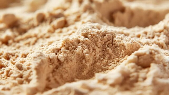 Close up view of protein powder, capturing its fine texture and the subtle variations in color, creating an abstract and textured background