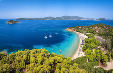 Panoramic aerial view of the beach  at Tsougrias island with the bay and town of Skiathos,...