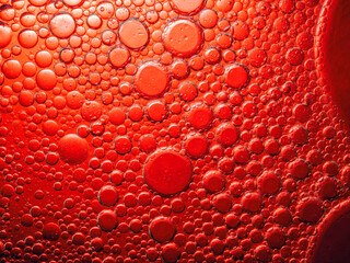 Abstract Background Red oil Macro Colorful artistic of oil drop floating on the water. macro red bubble oil of wallpeper, blood concept