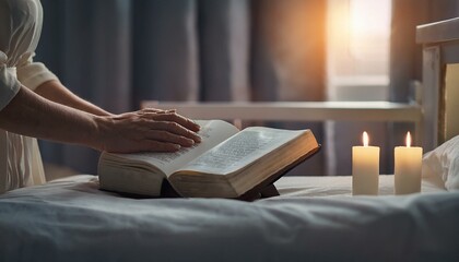 On a hospital bedside table, gentle hands lay a Bible next to a flickering candle.