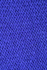 Macro texture of purple wool crochet sweater as background, close-up of purple crochet front surface, texture of woolen wool, crochet front surface
