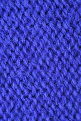 Macro texture of purple wool crochet sweater as background, close-up of purple crochet front surface, texture of woolen wool, crochet front surface