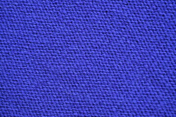 Macro texture of purple wool crochet sweater as background, close-up of purple crochet front surface, texture of woolen wool, crochet front surface