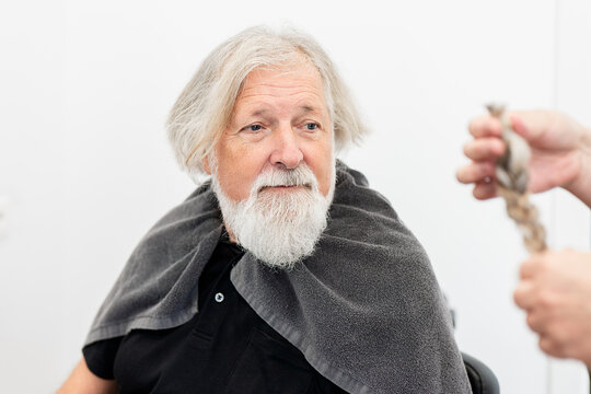 Elderly man donates hair for charity cause